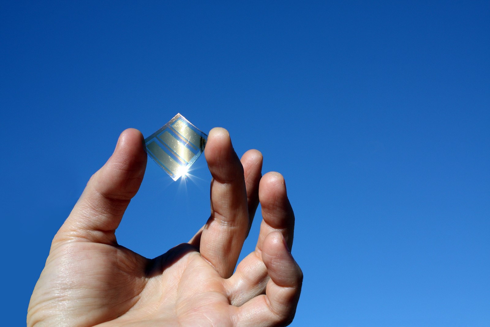 A hand holding a little mirror